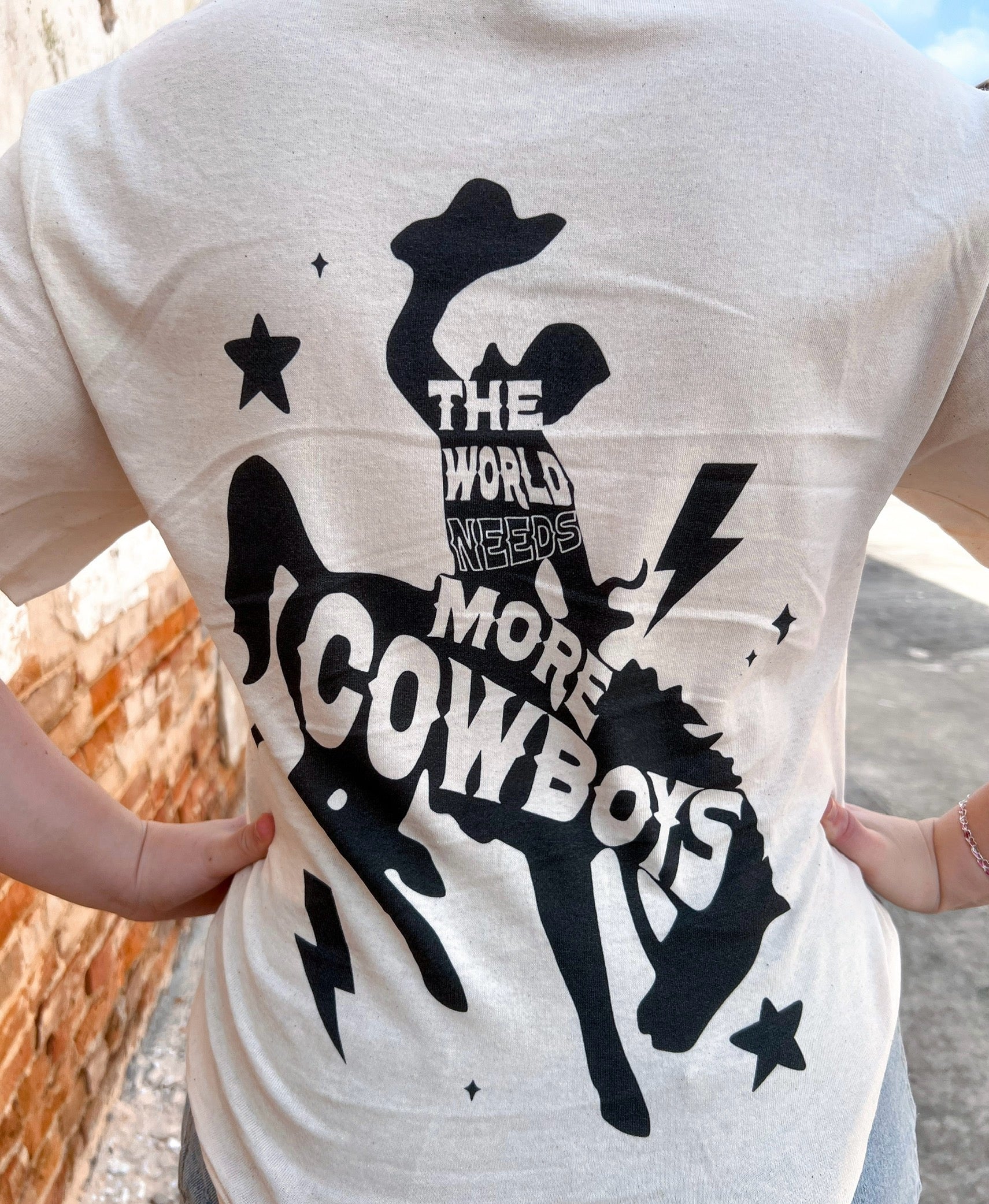The World Needs More Cowboys Graphic Tee-Apparel & Accessories-spirit+tribe-Max Retail,Tops Collection-The Twisted Chandelier